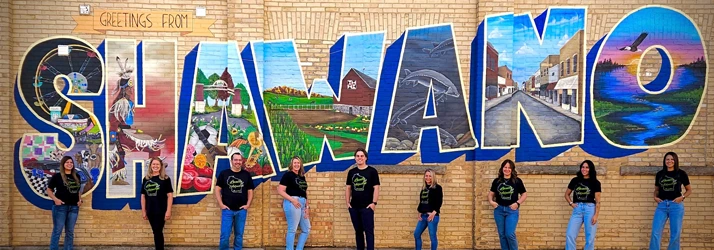 Picture of team members in front of Shawano sign